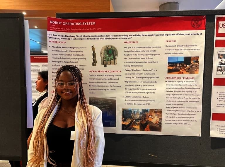 Tobi standing beside the Robot Operating System research poster at a USC showcase.